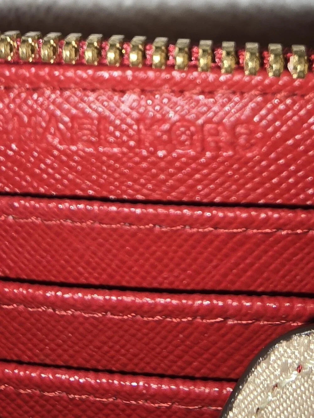 Michael Kors Red ostrich-patterned zip-around wallet featuring 1981 Goldtone